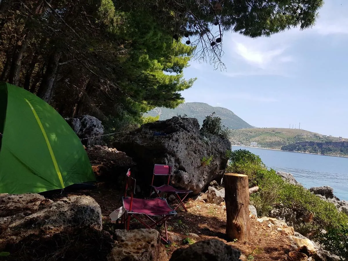 Tent and camp chairs looking out over the bay toward Himarë