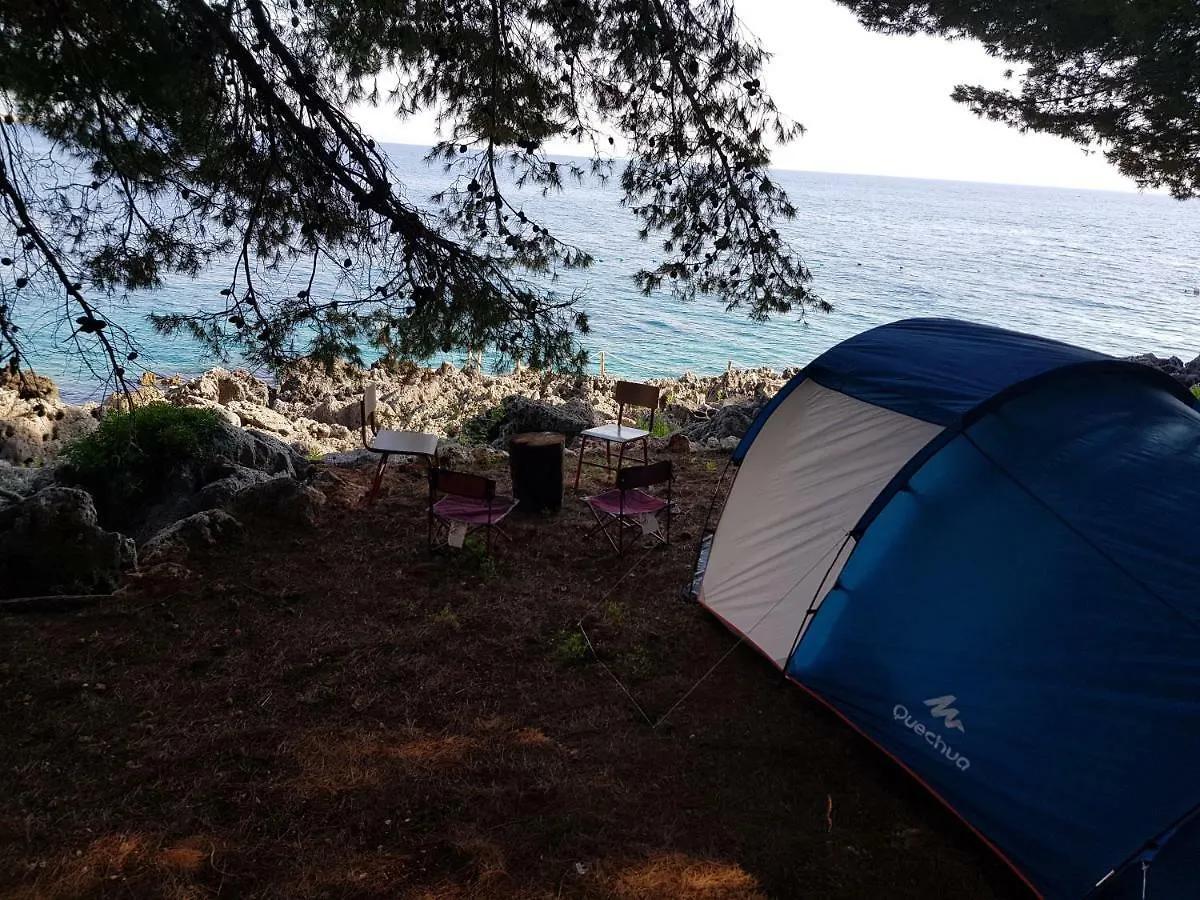 Tent and seating set up right above the sea at the camp
